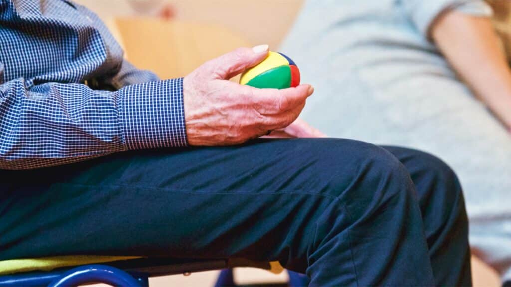 Patient Using Squeeze Ball For Physical Therapy